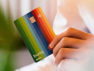 Carte bancaire Bunq arc-en-ciel tenue dans une main, illustrant la néobanque européenne et ses services en ligne.